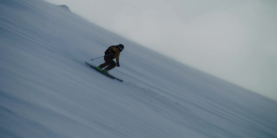 Skier shreds down a windy slope