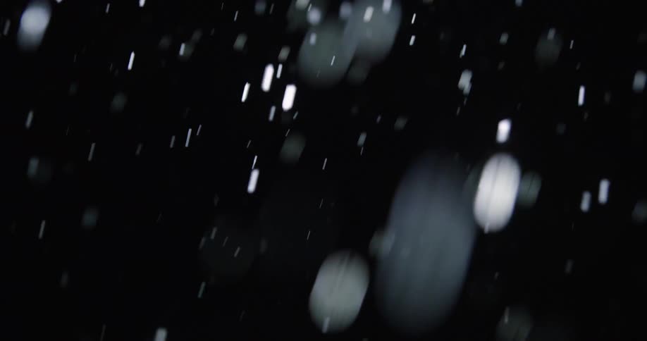 Snowflakes falling at night