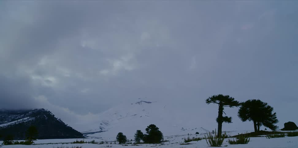 Clouds move across the mountains during winter
