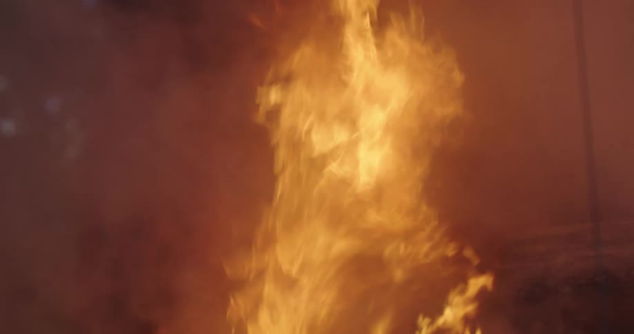 A large fire burns at night