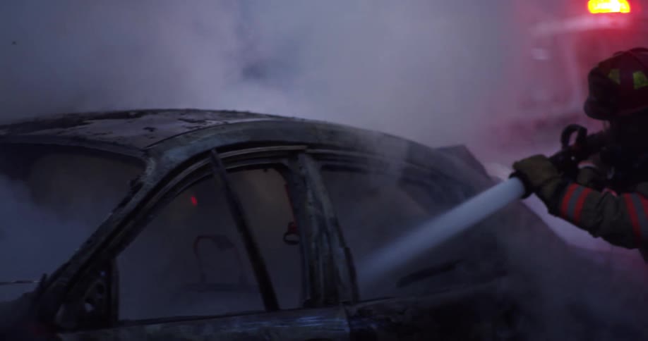 Firefighters extinguish car fire on a remote location