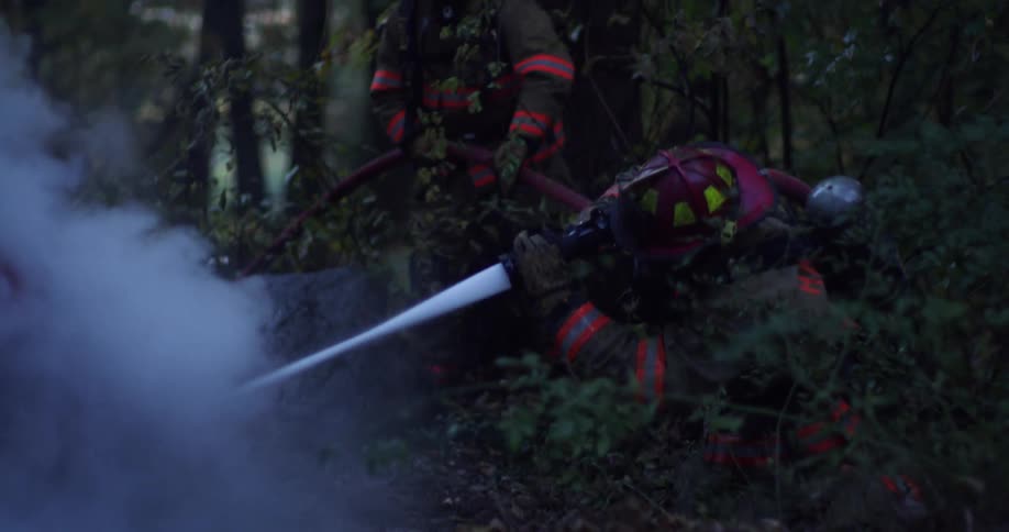 The firefighters spray the fire
