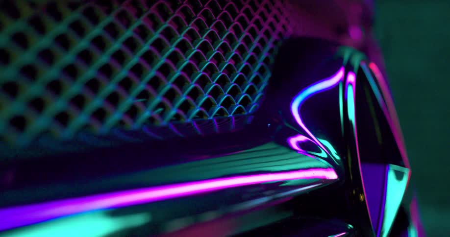Colorful lights shine and reflect on chrome and metal