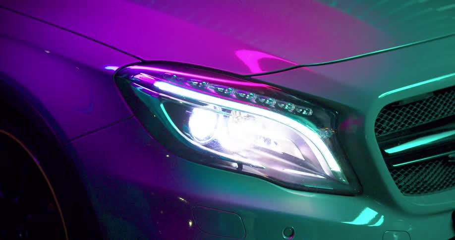 A close up of a car and headlight is displayed