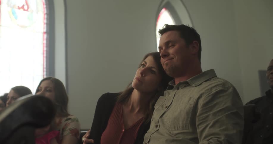 A man and woman sit side by side in the church