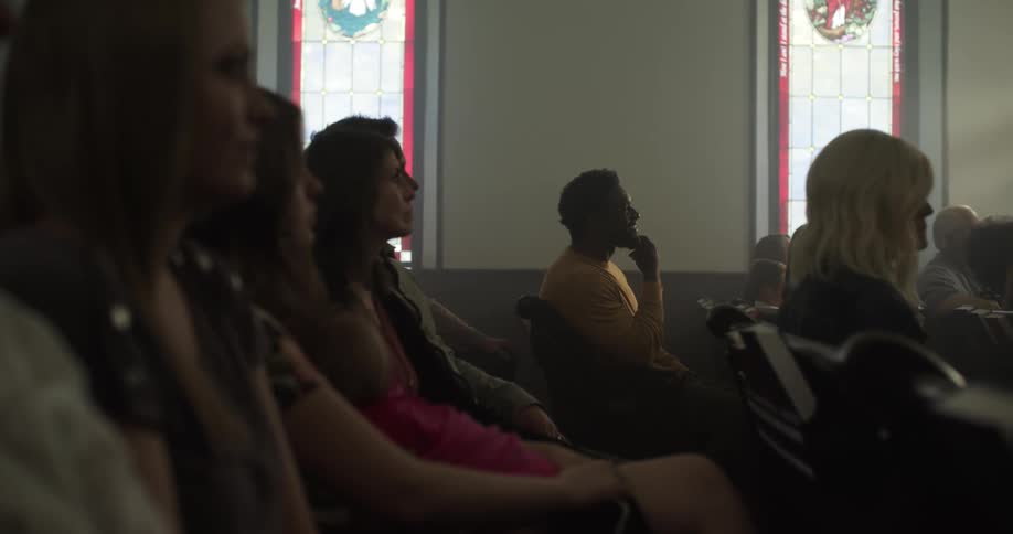 A group of people sit together in a church