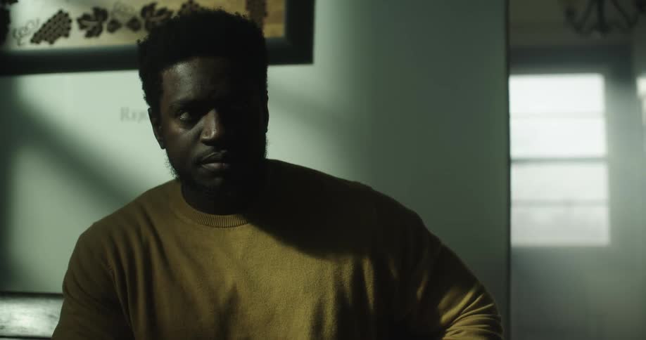 A man is sitting in a house