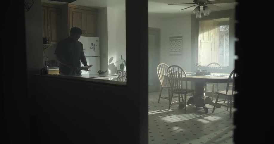 A man flips through mail in his house