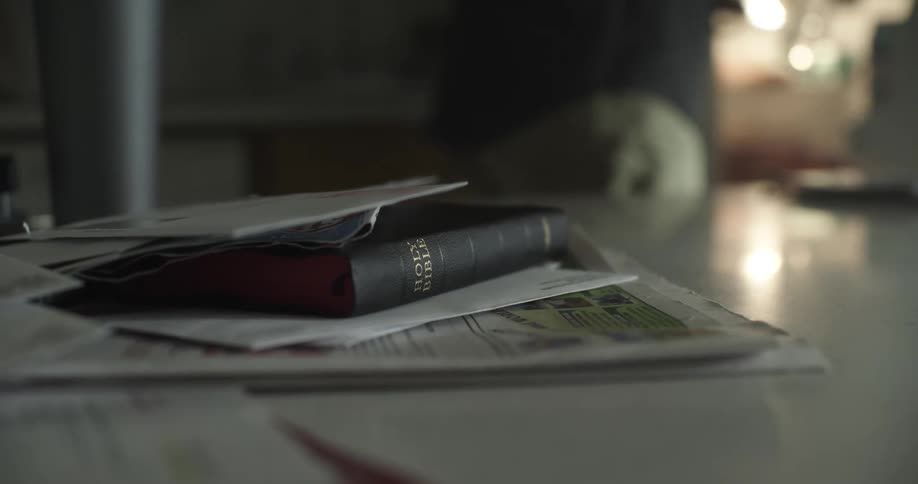 Bible laying on counter top between letters