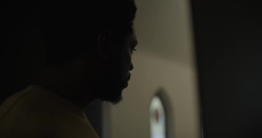 A man stands in a back doorway of a church