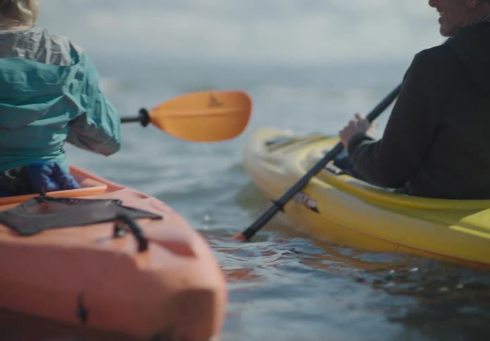 People are kayaking through the water