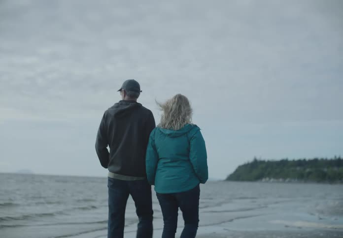 The man and woman walk on the beach