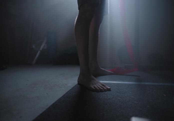 A person standing holding a red strap