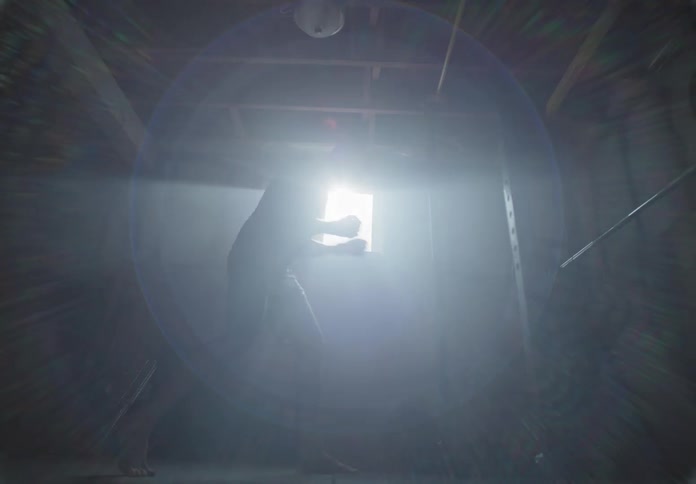 A man in a basement shadowboxing