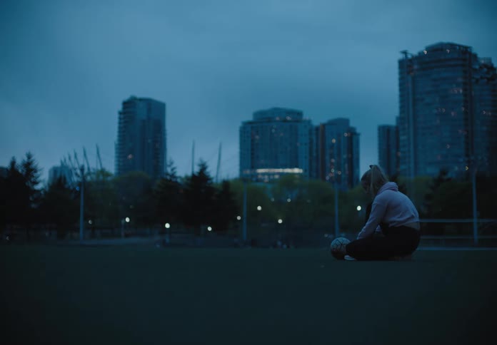 Woman on a football field in the early morning