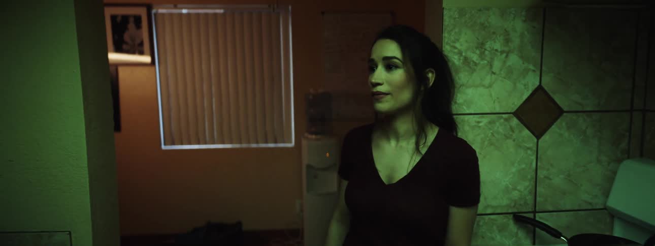 Couple stand in kitchen arguing