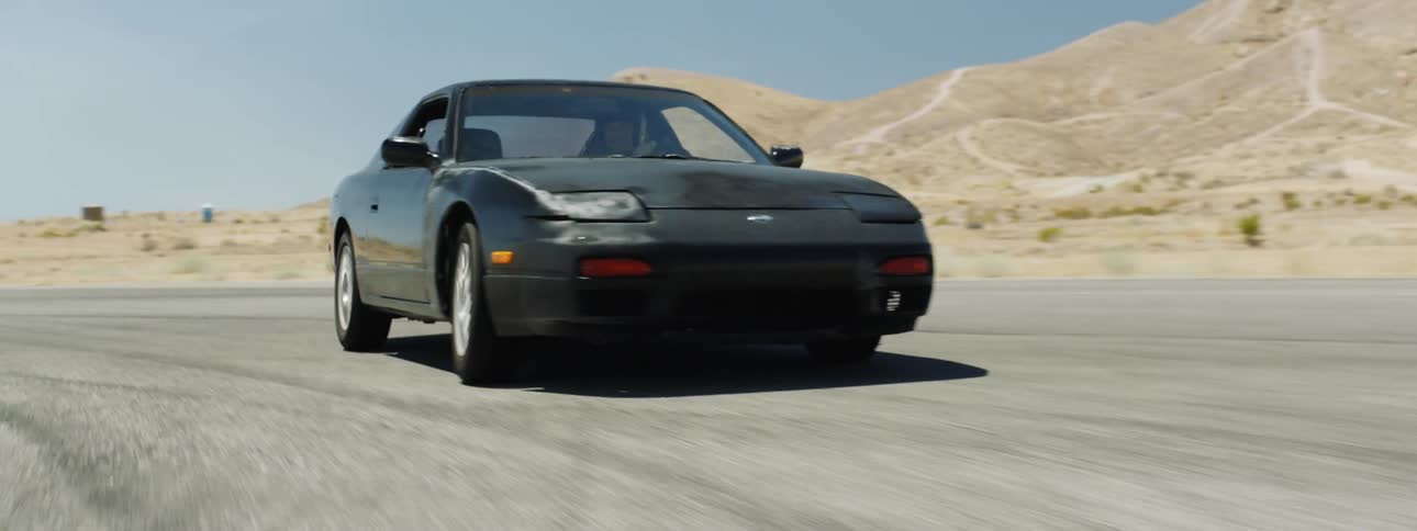 The car drives down the road