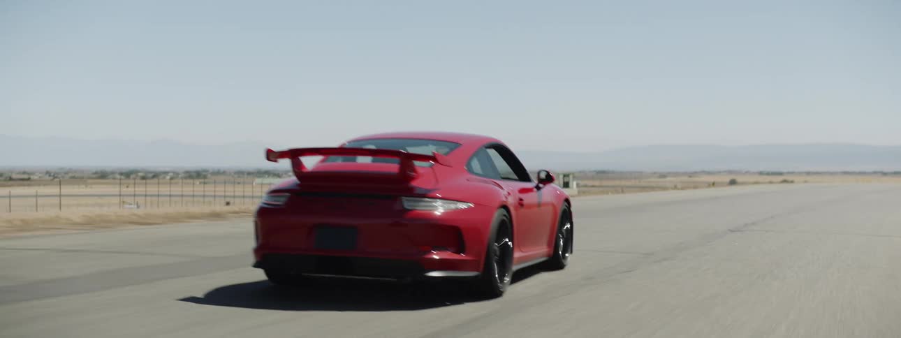 A red sports car driving on a track