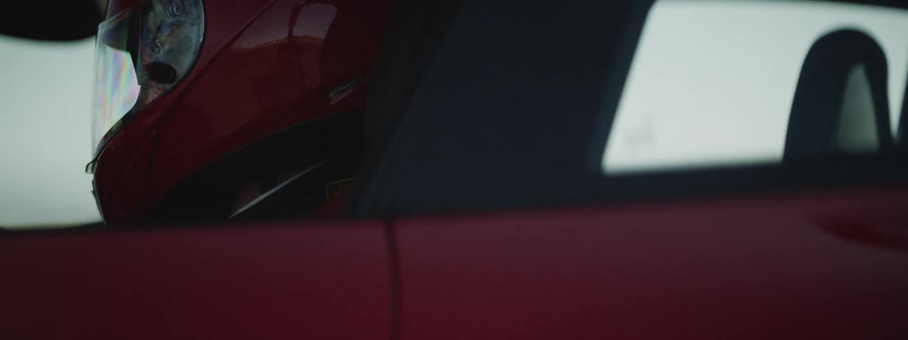 A race car driver in his car ready to drive