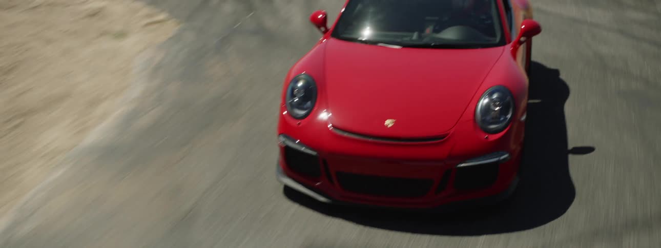 A sports car driving along a track in the desert at high speed