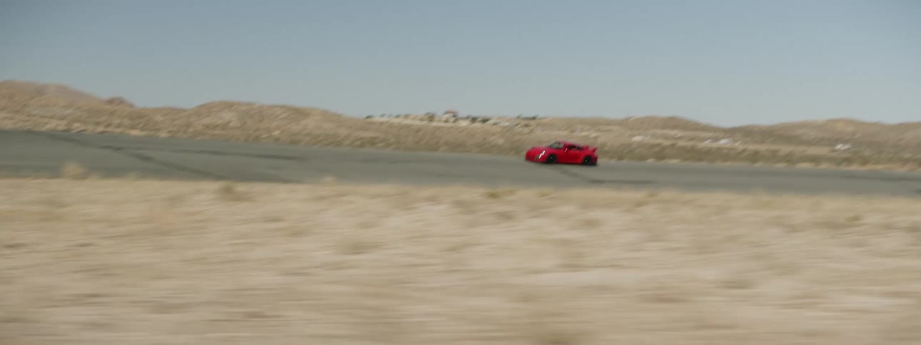 A red sports car driving on a track