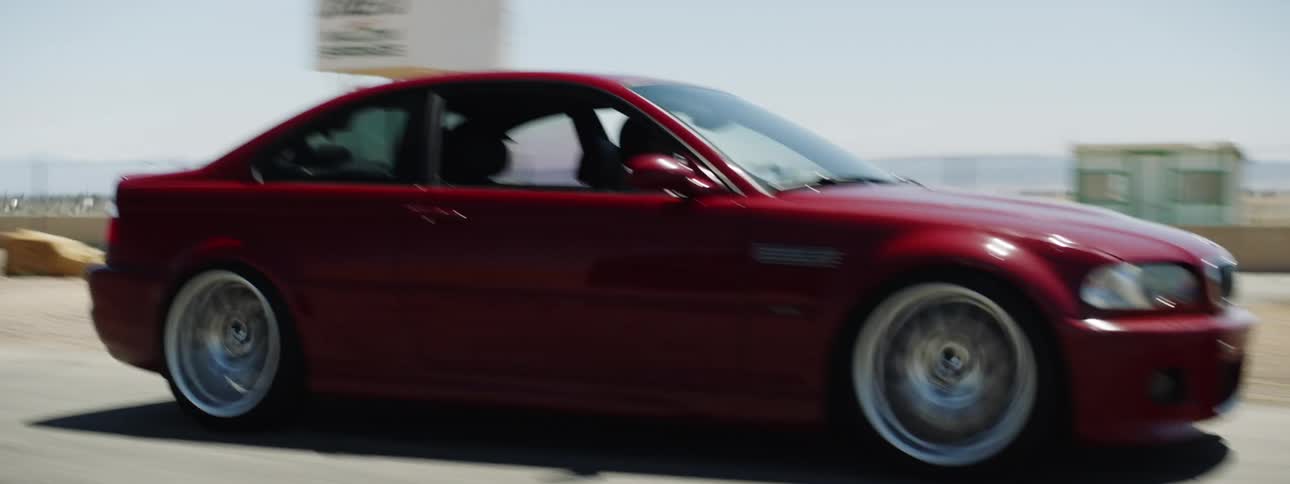 A red sports car driving on a track