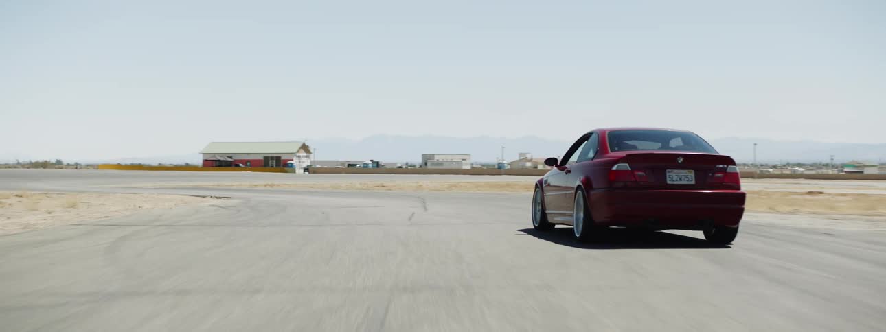 The car drives down the road