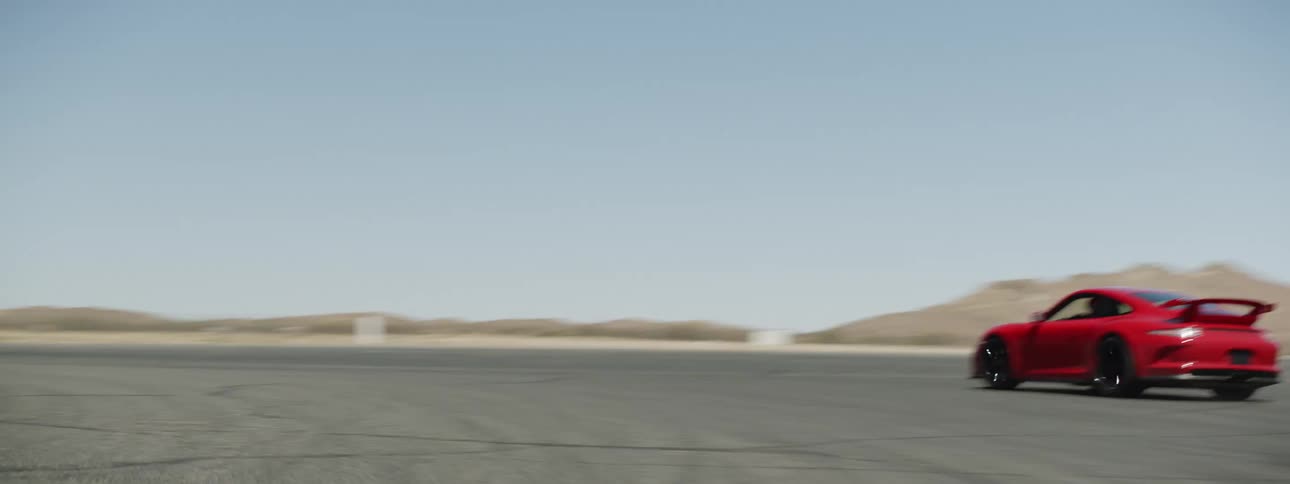 The red car is racing on the track