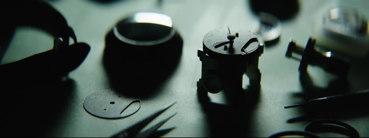 Table holding watch parts brightens then darkens