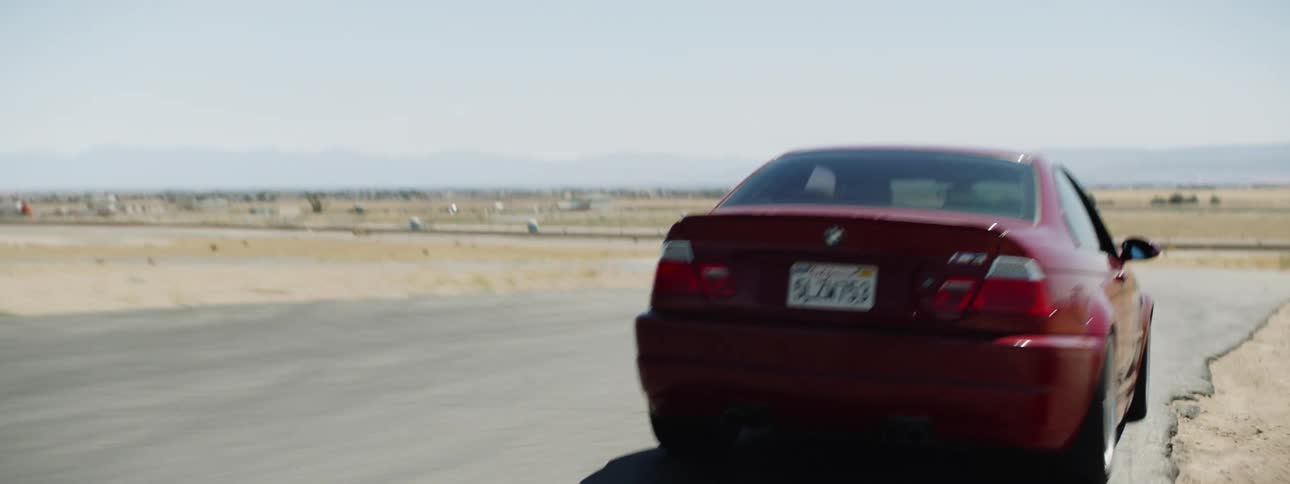 A red sports car driving on a track