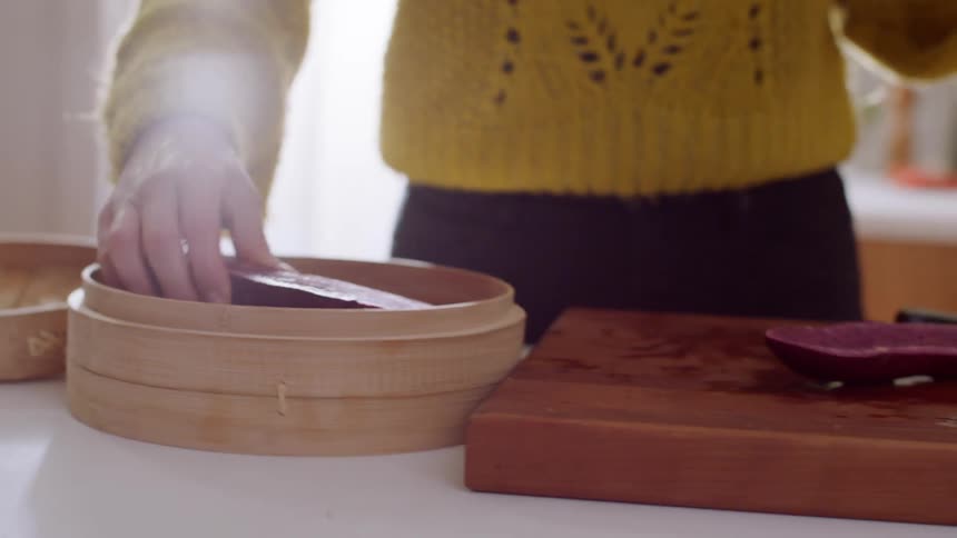 A woman is putting meat in a container