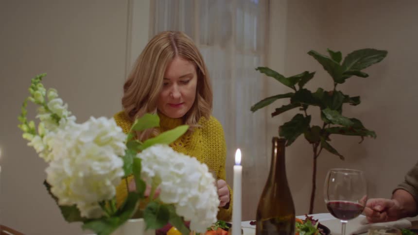 A couple enjoy a meal in their dining room