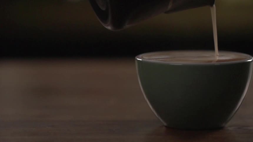 Coffee is being poured into a cup