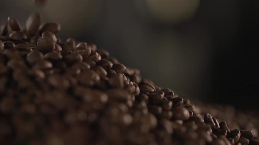 Coffee beans fall into a pile