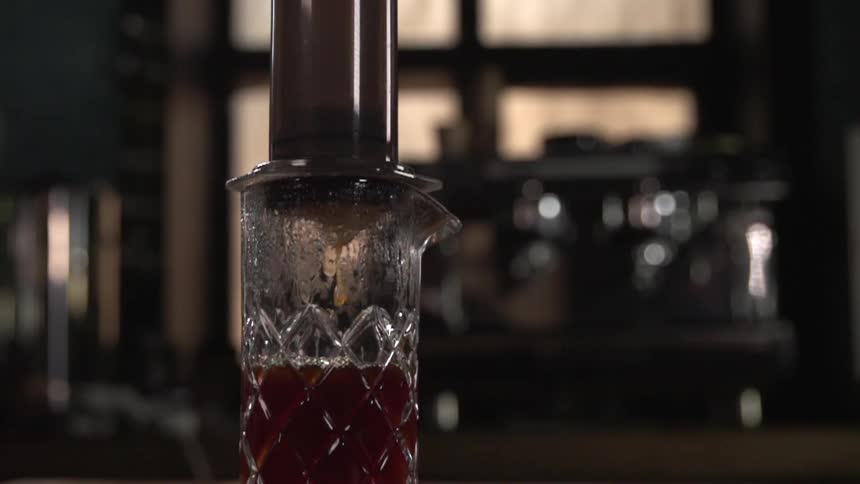 A red liquid being squeezed into a pitcher