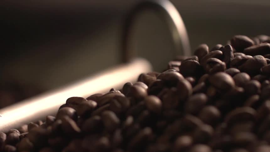A machine is turning coffee beans
