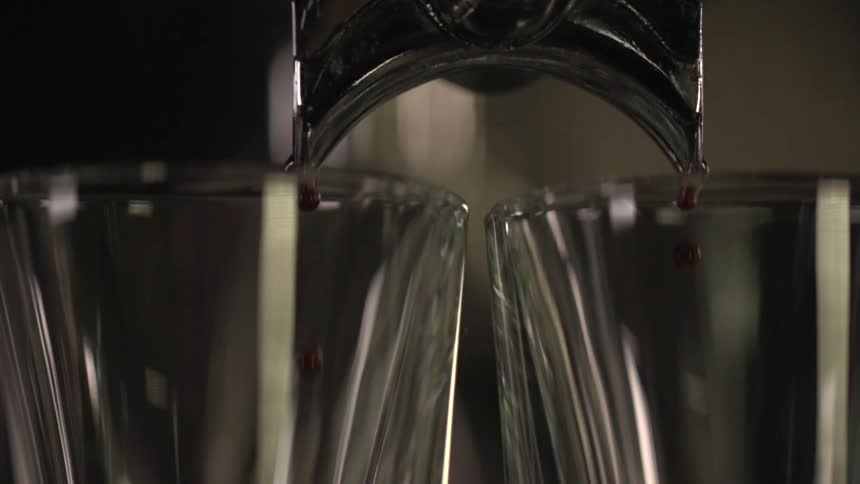 Liquid is being poured from a machine into a cup