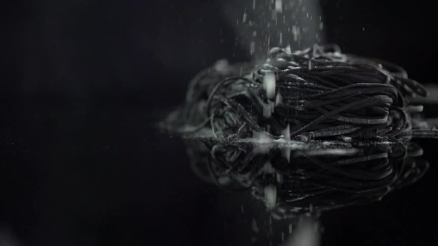 Flour sprinkled over dark noodles