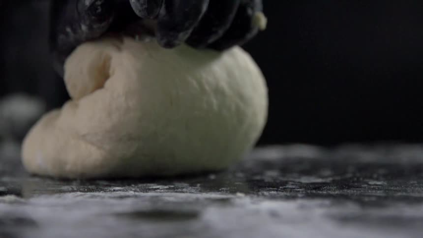 Hands rolling and kneading dough