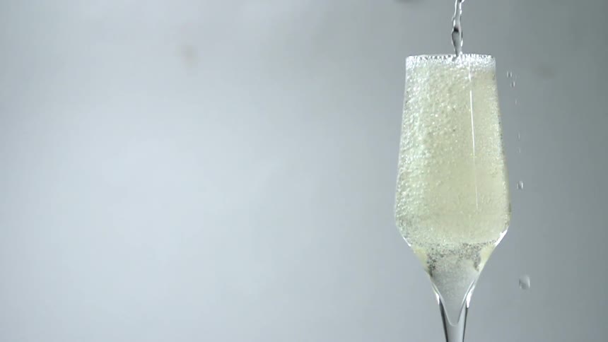 Champagne being poured in a champagne flute