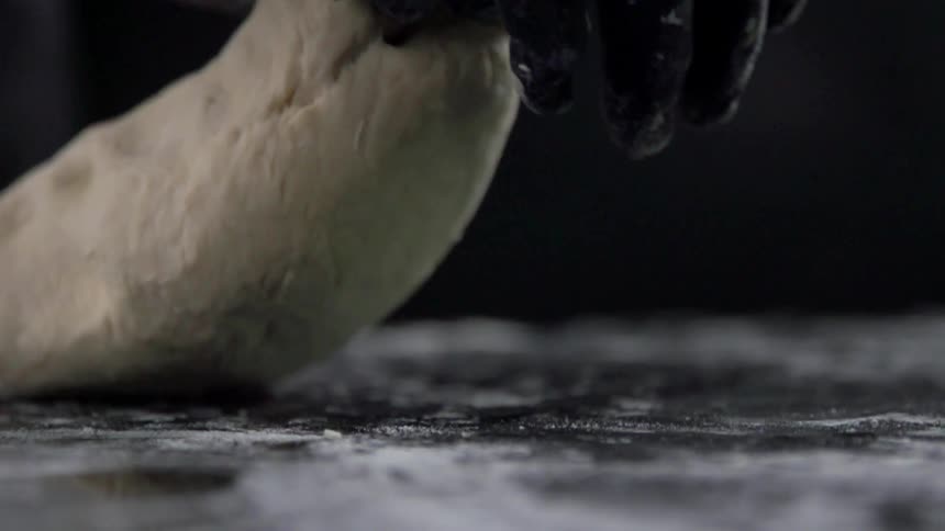 A person kneads dough