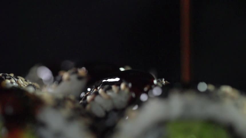 A banana split getting covered in liquid chocolate