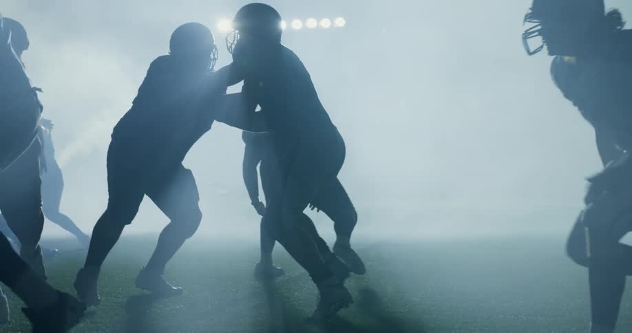 Football players running and tackling one another