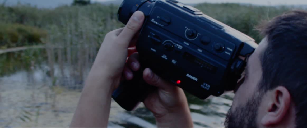 A man films the landscape