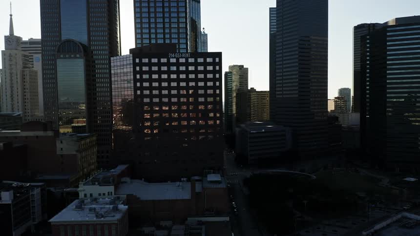 Skyscrapers in a downtown area are illuminated by the morning sun