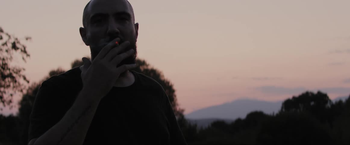 A man smokes a cigarette