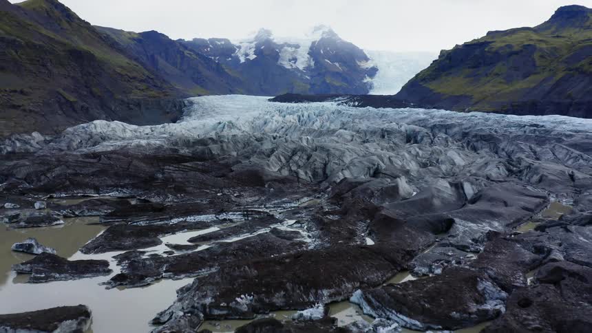 A frozen river wanders through the mountains