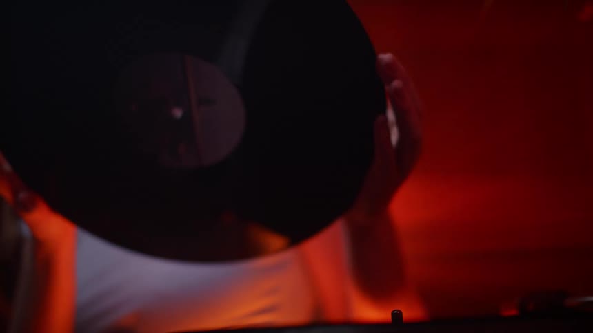 A teenager puts a record on a record player