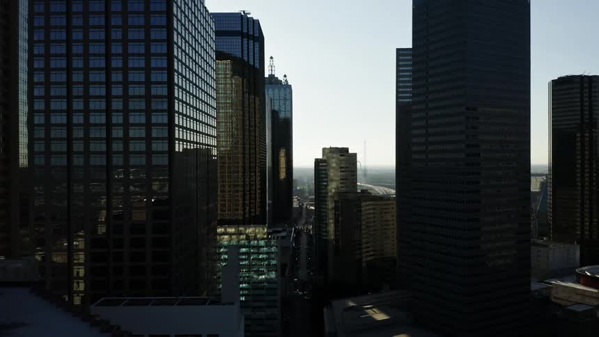 An aerial view of a downtown urban city is displayed