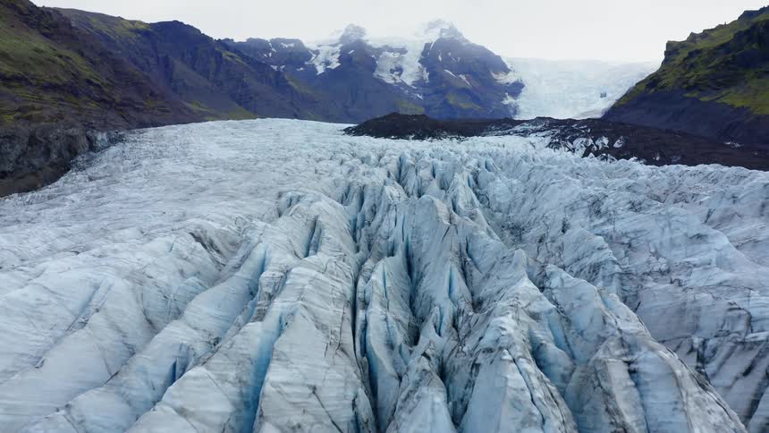 Massive glacier fills valley between mountains